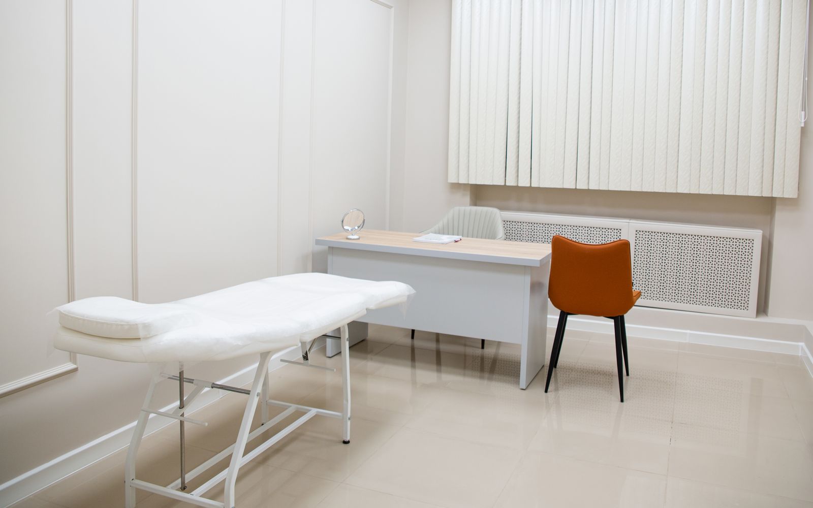 Consulting room with a desk, chair and examination couch