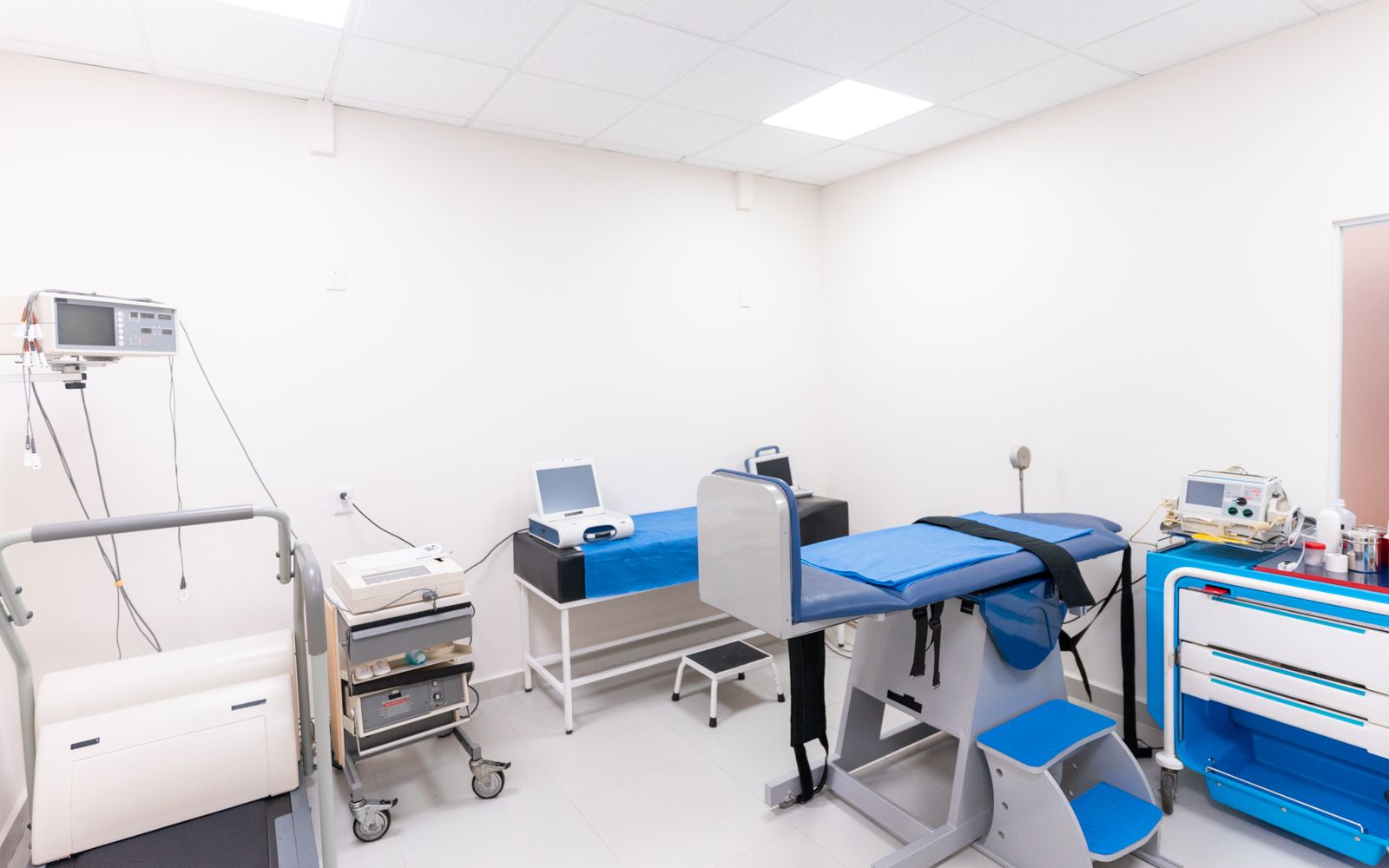 Treatment room with a procedure couch and monitoring equipment
